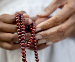 Hands Holding Beads