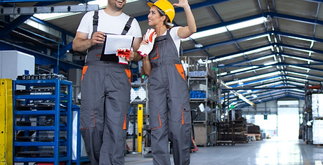 factory-workers-work-wear-yellow-helmets-walking-through-industrial-production-hall-discus