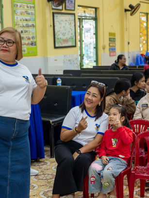 A Philippine social welfare delegate takes a selfie with children at Hope Village Da Nang during a community visit organized by Visit Indochina, capturing warm and joyful moments of cultural connection