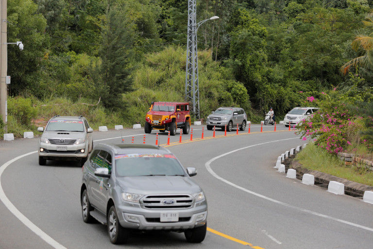Caravan convoy with colorful off-road vehicles driving through Central Vietnam