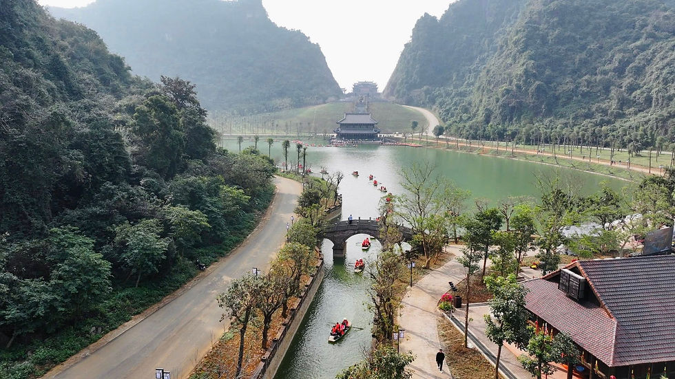 An aerial view of Thung Ui showing Dragon’s Eye Lake and the surrounding limestone mountains typical of the Trang An karst landscape.