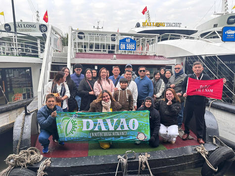 Tourists from Davao, Philippines pose for a group photo aboard a cruise in Ha Long Bay during their Northern Vietnam tour.