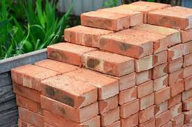 pile of red bricks stacked up in a 3m3 skip bins