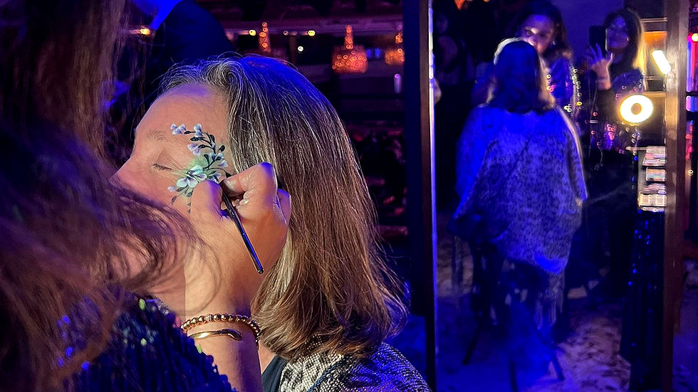 adult face art in motion creating a delicate blossom and vine design