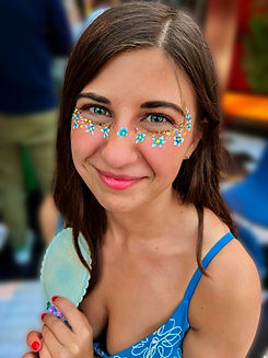 Colourful floral face painting for an adult event guest