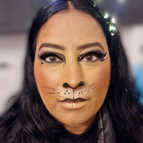 Adult Halloween face painting with theatrical cat make-up