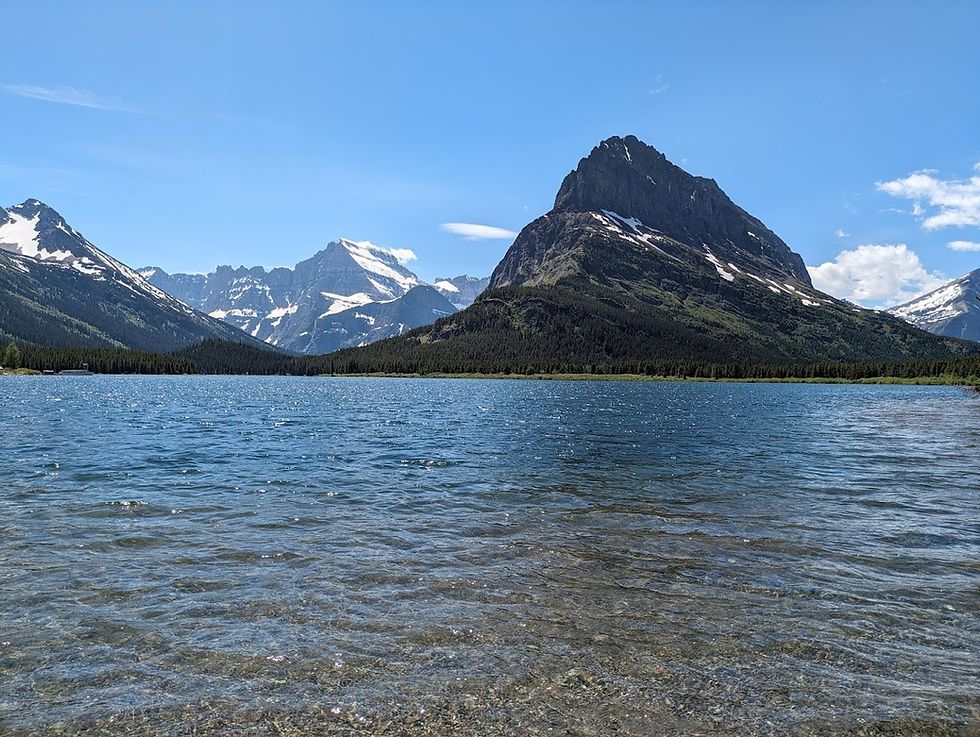 Clear alpine water and dramatic peaks at Swiftcurrent Lake in Many Glacier, Glacier National Park.