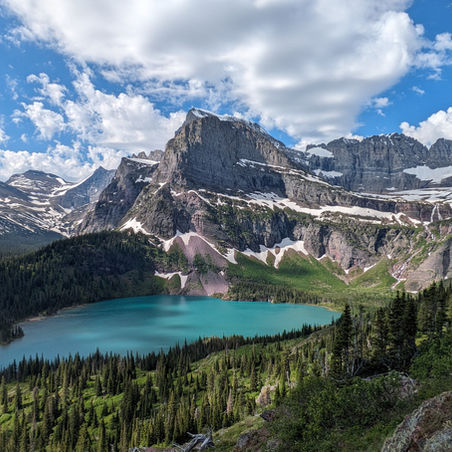 View of Grinnell Lake from above in Glacier National Park Montana with turquoise water and surrounding mountains