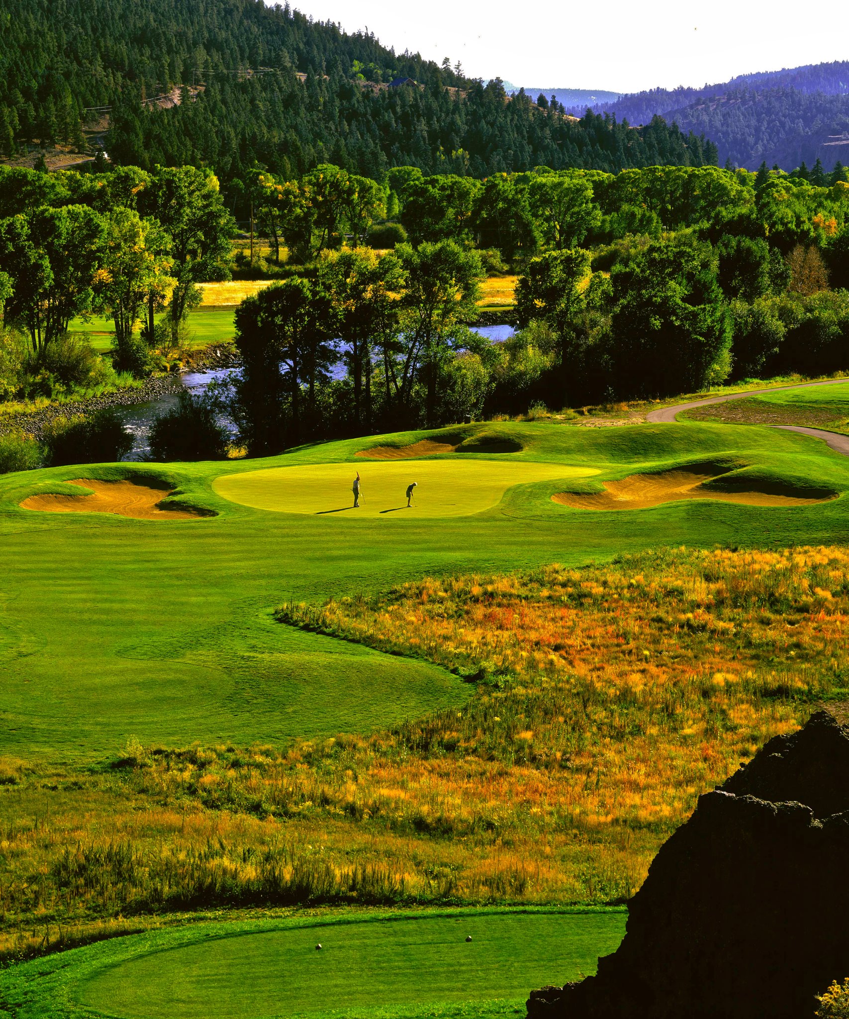 The layout offers two very different nines. The front nine play alongside and over the Rio Grande. The back nine winds through pine, aspen, and cottonwood trees, and impressive rock formations. The back offers dramatic elevation changes and tee shots that have the feeling of hitting off the edge of a mountain.