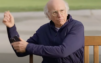 Larry David taking a "free" golf lesson.