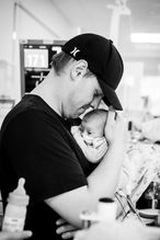 perth-birth-photographer-captures-new-dad-holding-prematurely-born-son-sniffing-his-head-while-he-cuddles-baby-born-at-24-weeks-in-king-edward-memorial-hospital-perth-nicu-photography-project
