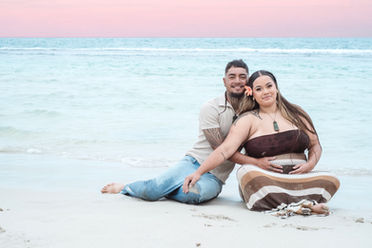 a-loving-couple-enjoying-perths-beautiful-sunrise-at-her-maternity-photoshoot-enjoying-the-pink-sky-at-fishermans-hollow-in-yanchep