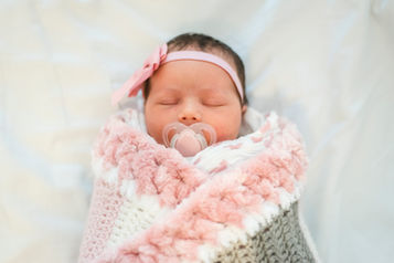baby-girl-wrapped-in-pink-and-grey-crocheted-blanket-with-pink-dummy-and-pink-bow-headband-perth-fresh-48-and-newborn-photographer-at-king-edward-memorial-hospital