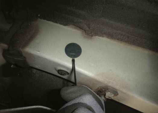 Factory weld-nut coverings removed from a 2019–Present Toyota RAV4 for hitch installation
