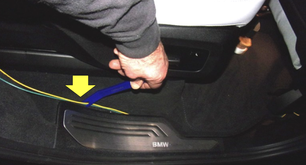 BMW X5 trailer-wiring installation routed through the rear cargo area