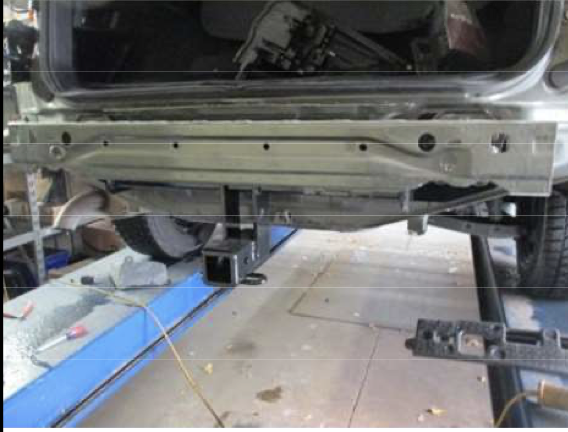 Factory bumper beam removed during older Subaru Outback hitch installation
