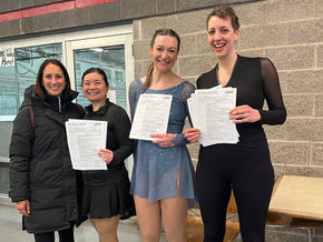 Adult skaters holding USFS test sheets