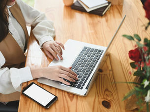 woman writing a blog on her laptop