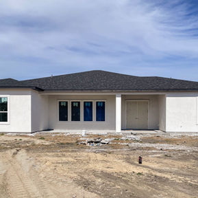 Rear exterior of a Jade Homes new construction home showing backyard and exterior layout