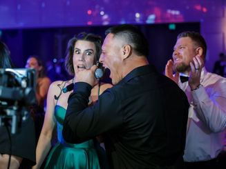 Perth event MC Ashlee Bunney doing live interviews in green dress at Perth Corporate Rumble
