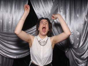 Ashlee Bunney, Perth wedding celebrant and MC, celebrating with arms raised at a wedding industry event.