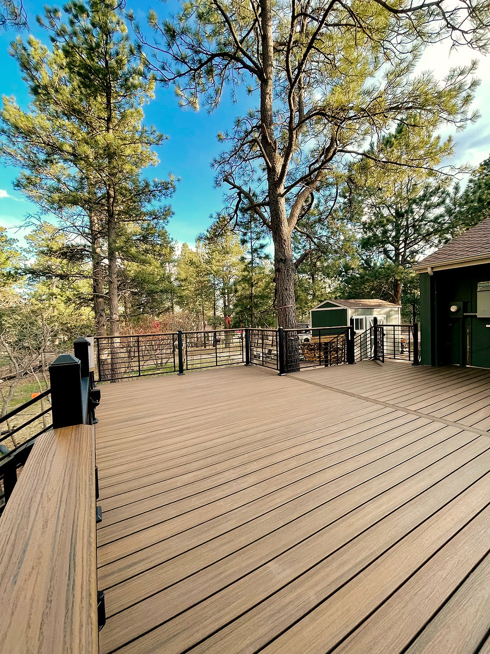 Modern outdoor deck by e&k construction surrounded by trees