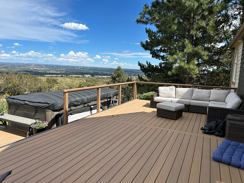 New wood deck with sofa and hot tub, showing exterior home carpentry services.