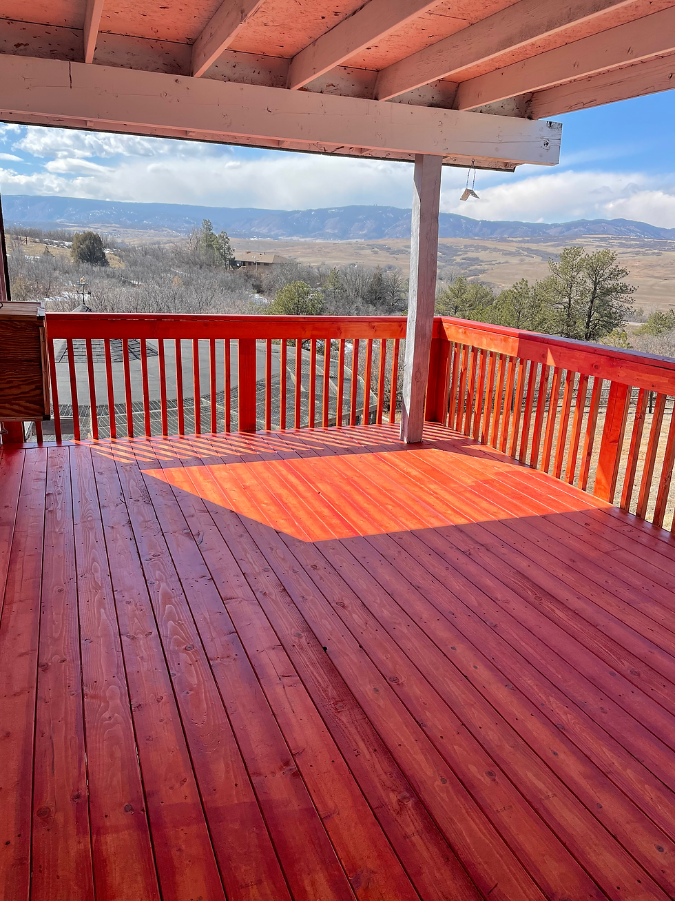 Red stained wood deck with exterior home carpentry services.