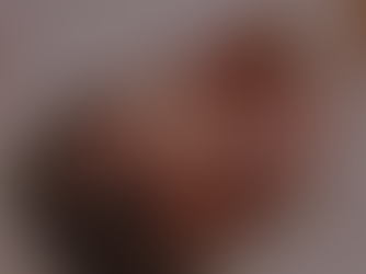 a newborn baby us cuddled up in a white blankert