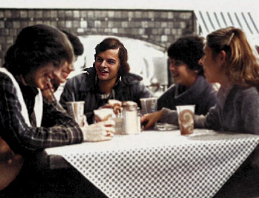 5 Notre Dame students sitting at a table drinking coffee and soda at the Oak Cafe in the South Dining Hall at night. University of Notre Dame. Autobiography of Dr. Anthony J. Carbone.