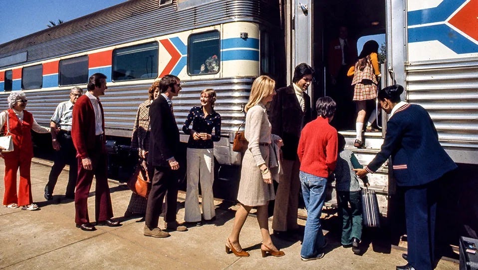 Photograph of passengers boarding an Amtrak passenger train circa 1980.  Autobiography of Dr. Anthony J. Carbone.