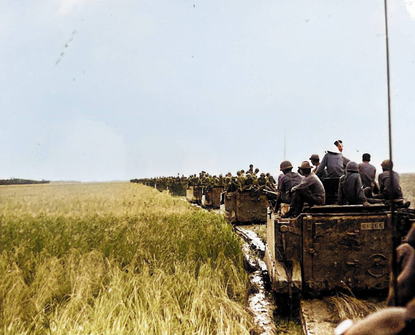 Republic of Vietnam Armored Unit on Patrol in Mekong Delta.  Line of American made M113 armored personnel carriers (APCs) and M114 armored reconnaissance vehicles.Part of the autobiography of Dr. Anthony J. Carbone, Son in the Shadow of a Green Beret Hero.