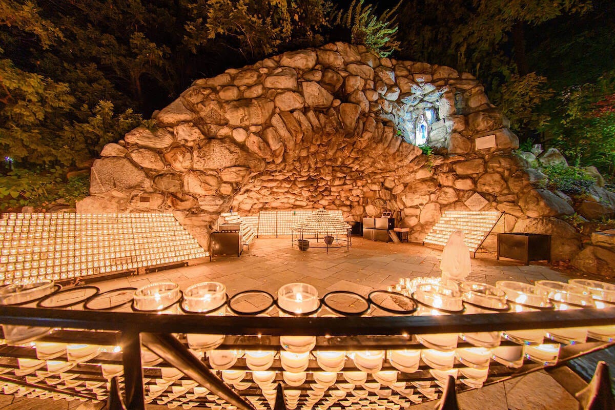 Photograph of the famous Grotto at the University of Notre Dame. Taken at night with all of the candles in the grotto lit. Autobiography of Dr. Anthony J. Carbone.
