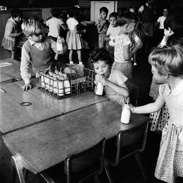 Children drinking milk from tiny glass milk bottles in the cafeteria in Vermont in the 1960s.Part of the autobiography of Dr. Anthony J. Carbone, Son in the Shadow of a Green Beret Hero.