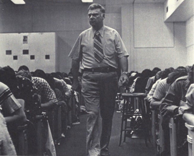 Dean Emil T. Hofman proctoring the weekly Friday Quiz. Professor of Chemistry and Dean of Freshmen Year Studies. University of Notre Dame.
