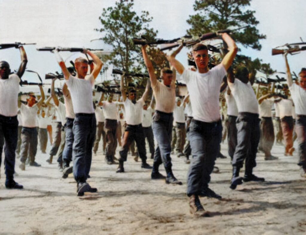 U.S. Army ROTC Cadets performing Physical Training (PT) with their M16 rifles over thier heads.  Biography of Dr. Anthony J. Carbone.