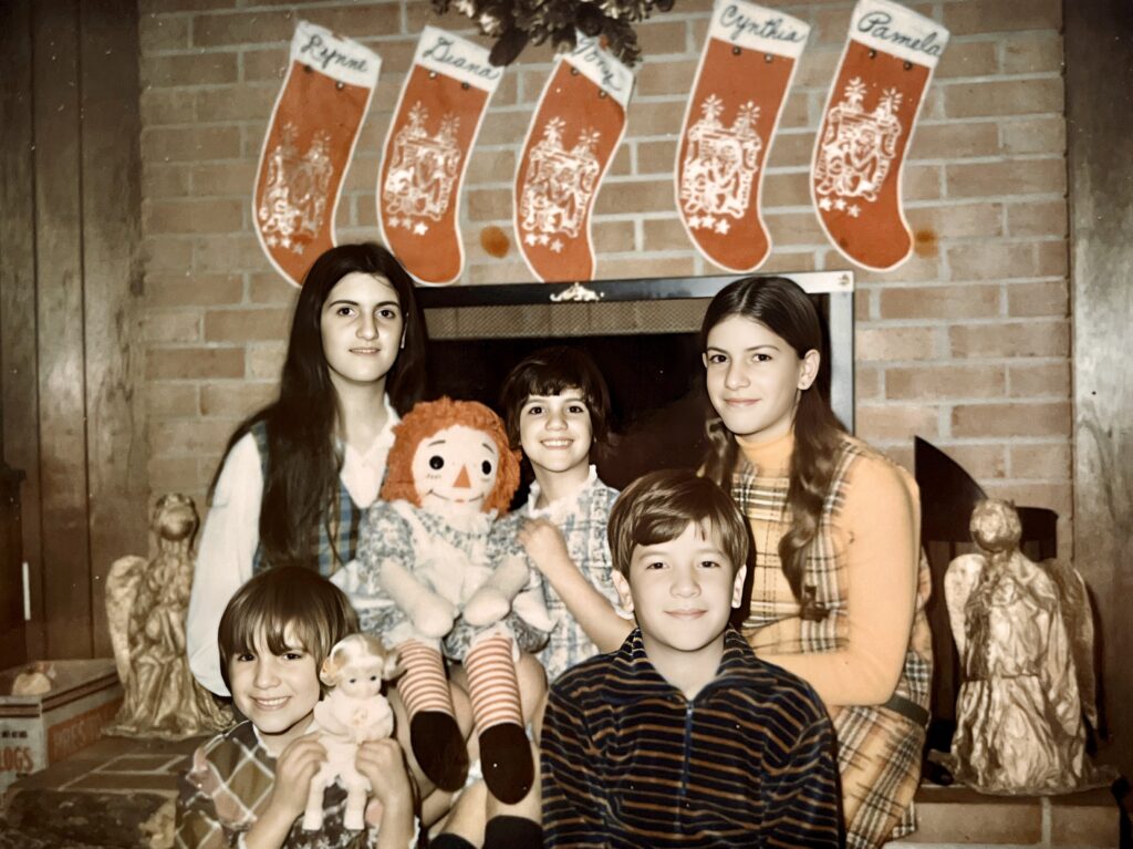 Photograph of me with my four sisters at Christmas time with our stockings hanginf on the fireplace.  Lynne, Diana, Tony Jr, Cynthia & Pamela.  Biography of Dr. Anthony J. Carbone.