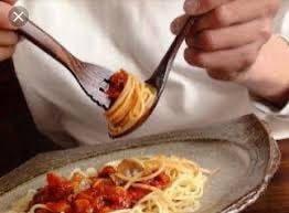 Photo of chef eating spaghetti with red sauce the Italian way, swilling the spaghetti in a spoon.Part of autobiography of Dr. Anthony J. Carbone, Son in the Shadow of a Green Beret Hero.