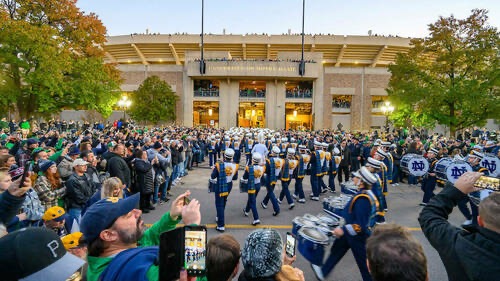 Photograph of Notre Dame Stadium with Notre Dame Marching Band and surrounding students.  Autobiography of Dr. Anthony J. Carbone.