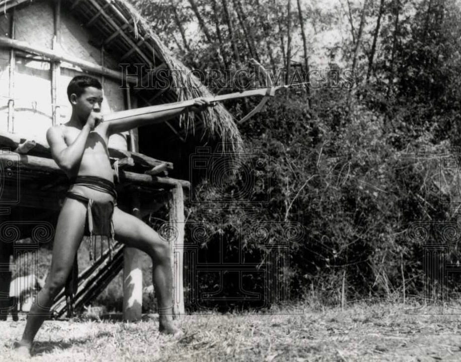 Montagnard soldiers supporting MACV-SOG forces in Ban Mê Thuôt. One is demonstrating the use of the blowgun — another favorite of SOG operatives (along with the crossbow).Part of the autobiography of Dr. Anthony J. Carbone, Son of a Green Beret Hero.