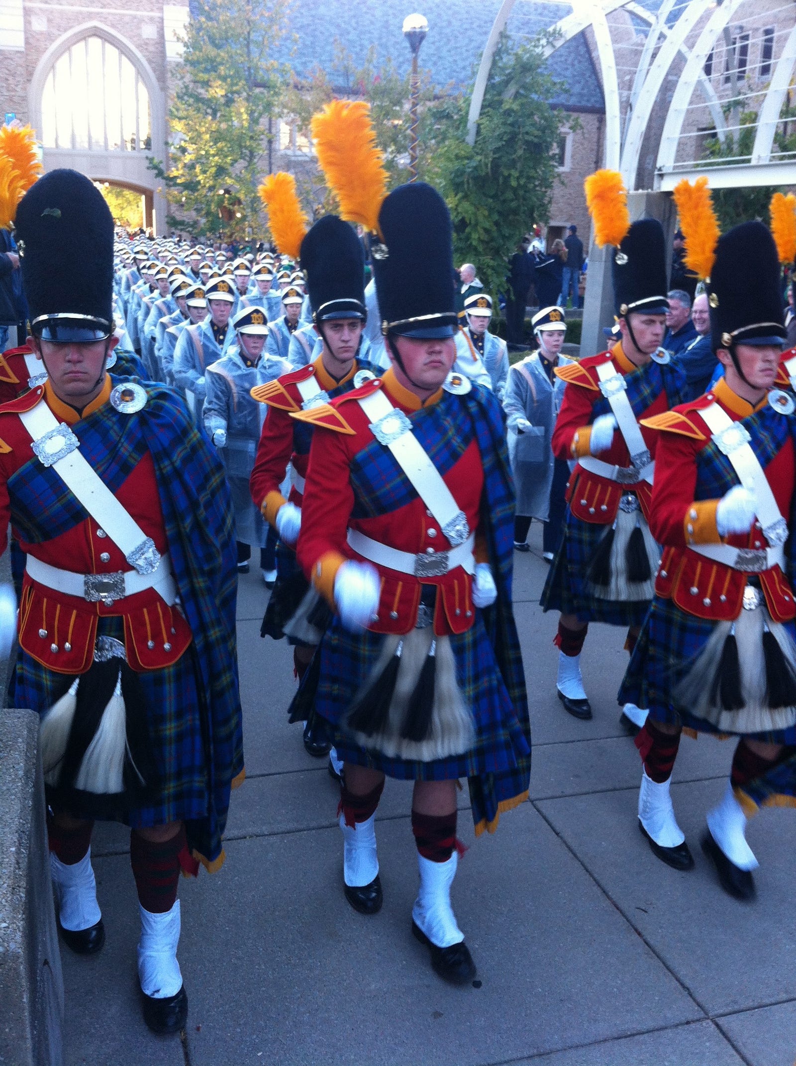 University of Notre Dame Irish Guard in red jackets and plaid kilts leading the Notre Dame Marching Band to the Stadium on Game Day. Autobiography of Dr. Anthony J. Carbone