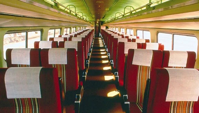 Photograph of an empty Amtrak passenger car (2x2) circa 1980.  Autobiography of Dr. Anthony J. Cabone.