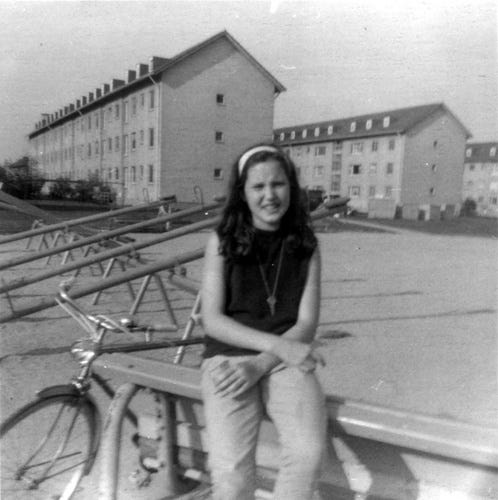 An unknown military dependent (Army brat) resting in the playground behind housing units in Patrick Henry Village.
