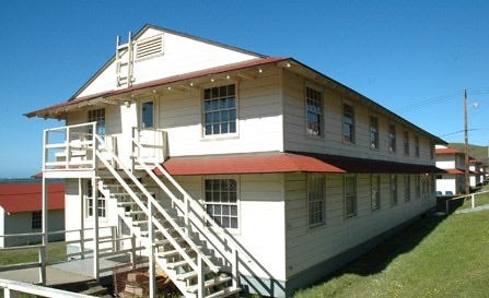 Exterior view of a typical World War II Army barracks, 2 stories with steps to second floor.  Found on Camp Forsyth for Army ROTC Advanced Camp.  Biography of Dr. Anthony J. Carbone