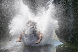Cadet slashing into the water at the end of the Slide For Life at U.S. Army ROTC Advanced Camp.  Biography of Dr. Anthony J. Carbone.