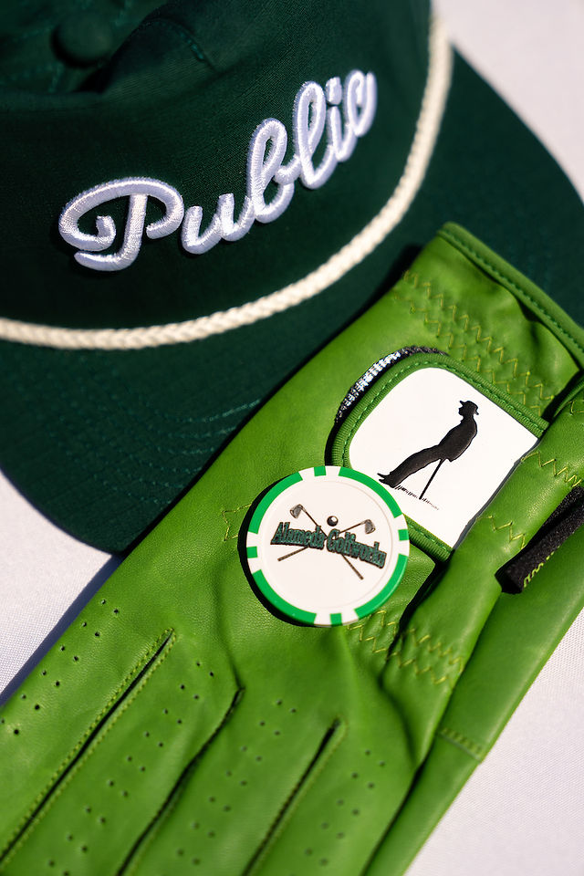 Green golf glove and hat with "Public" text, a golf ball marker. Corica Park