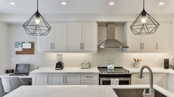 white wooden kitchen cabinet with black pendant lamp_edited