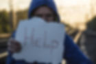 Canva - Man Holding Help Sign.jpg