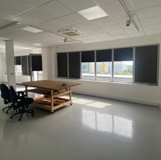 Sunlight filtered through blackout roller blinds in a London coworking space