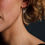 Thumbnail: Close up of model wearing a pair of Aquamarine Teardrop Earrings